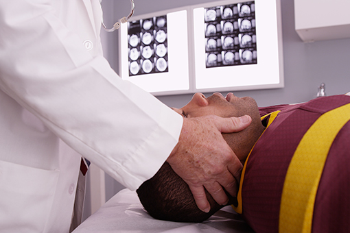 Doctor Treating Man with Post Concussion Syndrome at a Clinic in Tampa FL