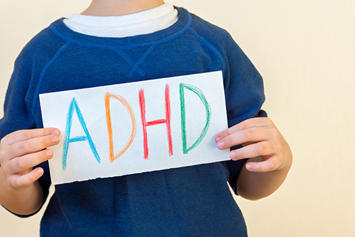 Child Holding Paper with ADHD Text In Need of ADHD Treatment in Tampa FL